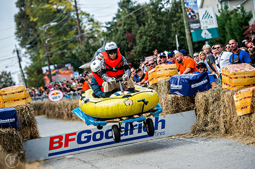 Jay Ferraro (right) and Mike Brose brace for impact as they clear the jump during the Red Bull Soap Box Derby in Atlanta on Saturday, October 24, 2015. 
