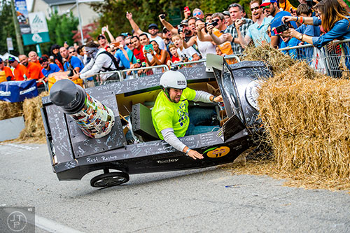 The driver of Lighthouse Family Retreat is ejected from his vehicle as he crashes during the Red Bull Soap Box Derby in Atlanta on Saturday, October 24, 2015. 