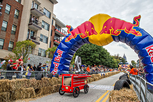 Dion Vidal crosses the finish line on North Ave. during the Red Bull Soap Box Derby in Atlanta on Saturday, October 24, 2015. 