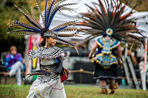 Dressed in ceremonial Aztec garb, Aaliyah Alfaro dances during the Indian Festival & Pow Wow at Stone Mountain Park on Saturday, October 31, 2015. 