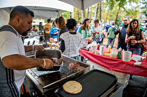 David Cervantes (left) cooks ground beef during the Dia De Muertos, or Day of the Dead, Festival at the Atlanta History Center on Sunday, November 1, 2015. 
