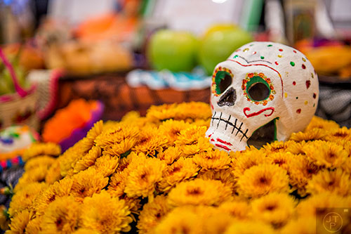 Decorated skulls, flowers, fruit, food, photos and other decorations are displayed during the Dia De Muertos, or Day of the Dead, Festival at the Atlanta History Center on Sunday, November 1, 2015. 