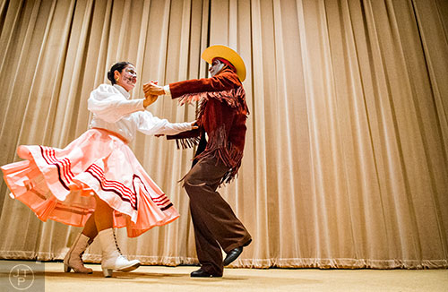 Hilda Levi (left) dances with Cydney Caarrubias during the Dia De Muertos, or Day of the Dead, Festival at the Atlanta History Center on Sunday, November 1, 2015. 