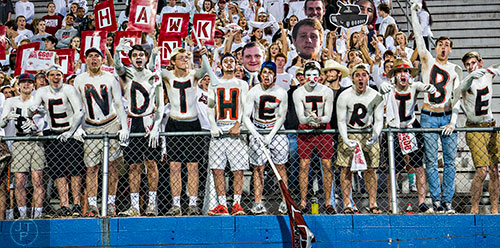 Hillgrove students cheer as their team steps onto the field before their game against McEachern on Friday, November 6, 2015.   