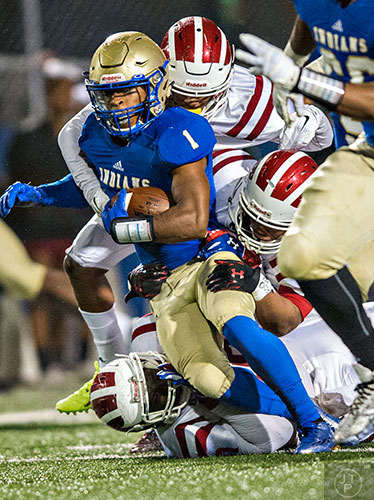 McEachern's Sam Jackson (1) ris tackled by Hillgrove's Lamar Fomby (bottom), Cameron Tew and Jalen Phelps on Friday, November 6, 2015. 