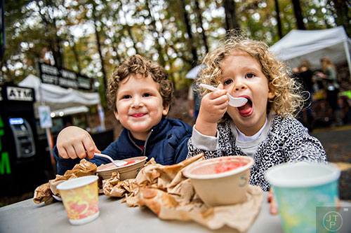 Seth Yehudai (left) and his sister Leah eat strawberry flavored ice during the Chastain Park Arts Festival on Saturday, November 7, 2015. 