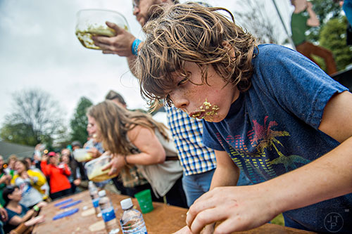 Elliott Davis (right) tries not to throw up as he competes in the cole slaw eating contest during the Cabbagetown Chomp & Stomp in Atlanta on Saturday, November 7, 2015. 