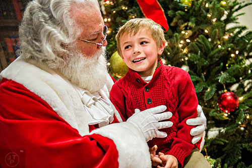 Oliver Membrillo (right) talks with Santa during the Dunwoody United Methodist Church Holiday Festival on Saturday, November 14, 2015. 