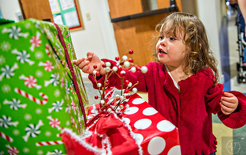 Finley Maddox investigates wrapped boxes during the Dunwoody United Methodist Church Holiday Festival on Saturday, November 14, 2015. 