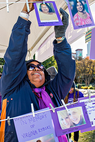 Sherri Grady hangs a picture of her mother before the start of the PurpleStride Atlanta 5k at Centennial Olympic Park in Atlanta on Saturday, November 14, 2015. 