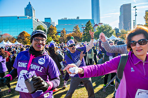Jose Garcia (center) warms up with stretches and zumba before the start of the PurpleStride Atlanta 5k at Centennial Olympic Park in Atlanta on Saturday, November 14, 2015. 