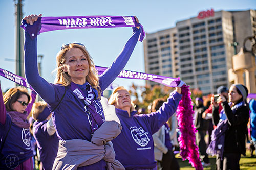 Sally Keichert (left) Gretchen Vaughan hold up wage hope sashes before the start of the PurpleStride Atlanta 5k at Centennial Olympic Park in Atlanta on Saturday, November 14, 2015. 