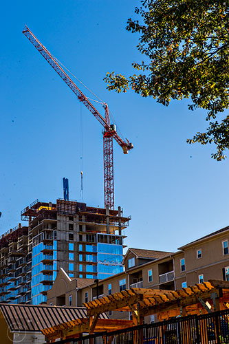 A crane rises above the buildings in Atlanta. Shot from West Peachtree and 12th streets.