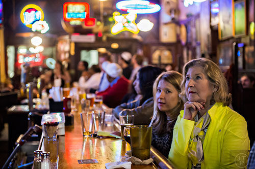 People watch the Republican Presidential debate from the bar at Manuel's Tavern in Atlanta.