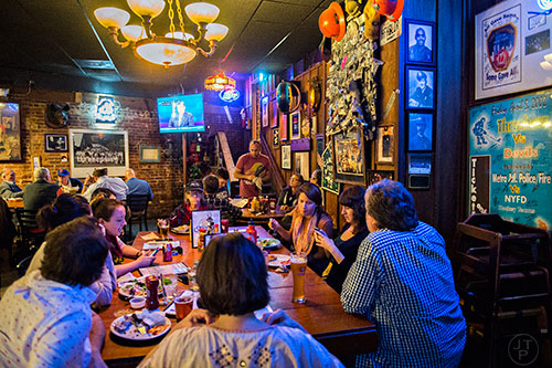 People watch the Republican Presidential debate at Manuel's Tavern's main dining room in Atlanta.