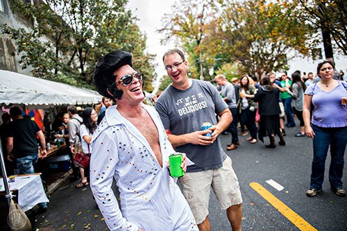 Dressed as Elvis, Buzz Burton (left) has a laugh with Todd Lakes during the Cabbagetown Chomp & Stomp in Atlanta on Saturday, November 7, 2015.