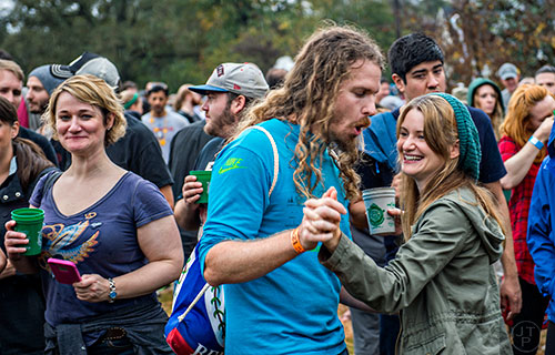 Caitlin Fonzo (right) dances with Craig Quinlan as Grits & Soul performs on stage during the Cabbagetown Chomp & Stomp in Atlanta on Saturday, November 7, 2015.