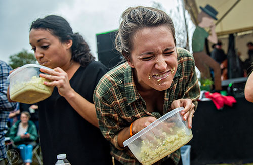 Anna Kristine Roth (right) and Candice Garcia compete in the cole slaw eating contest during the Cabbagetown Chomp & Stomp in Atlanta on Saturday, November 7, 2015.