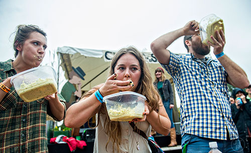 Anna Kristine Roth (left), Emily Ward and Riley Perszyk compete in the cole slaw eating contest during the Cabbagetown Chomp & Stomp in Atlanta on Saturday, November 7, 2015.
