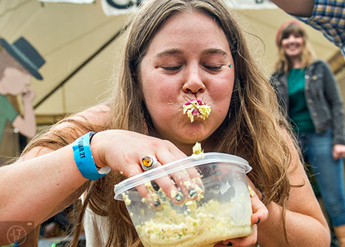 Emily Ward competes in the cole slaw eating contest during the Cabbagetown Chomp & Stomp in Atlanta on Saturday, November 7, 2015.