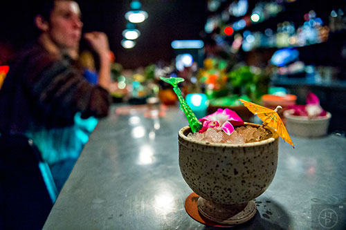 A Rough 'N Rowdy comes complete with an umbrella, a hibiscus flower and a swordfish stirrer inside S.O.S. Tiki Bar in Decatur.