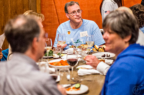 Allen Venet (center) talks with fellow supporters during the Lavista Hills viewing party at Sprig on Tuesday.  