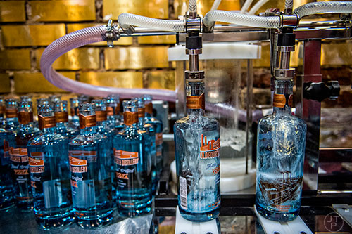 Bottles are filled with vodka during bottling day at Old Fourth Distillery in Atlanta.