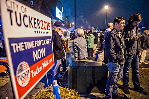 Julian Saden (right) and Codey Bearden hang out in downtown Tucker during the election night party on Tuesday.