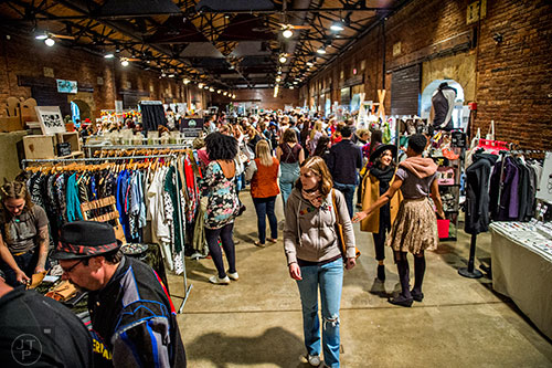 Molly Dorkey (center) walks through the crowd looking at artist booths during the Indie Craft Experience's Holiday Shopping Spectacular at the Georgia Freight Depot in Atlanta on Saturday, November 21, 2015. 