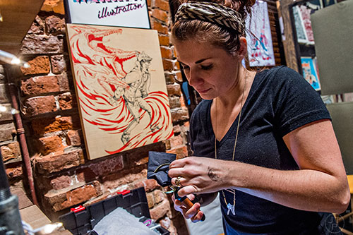 Michele Warren shapes a bracelet during the Indie Craft Experience's Holiday Shopping Spectacular at the Georgia Freight Depot in Atlanta on Saturday, November 21, 2015. 