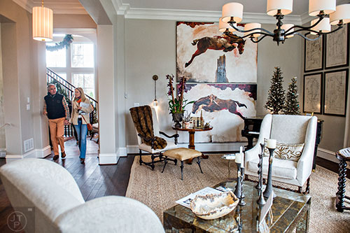 Carl Bouckaert (left) and Suzanne Sitherwood walk through the living room inside the 2015 Home for the Holidays Designer Showhouse located at 1150 West Garmon Rd. in Atlanta on Saturday, November 21, 2015. 