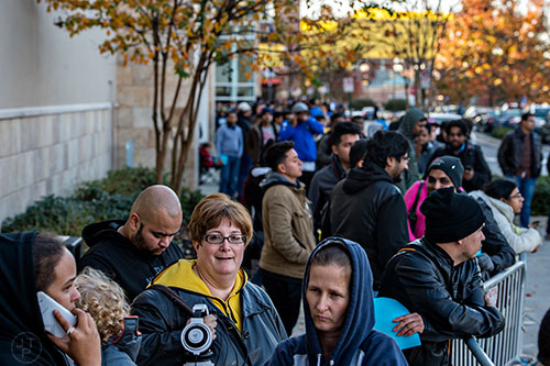 Jeannie Posner (center) stands in line outside of Best Buy Perimeter in Atlanta before the store opens for Gray Thursday on Thanksgiving night, Thursday, November 26, 2015. 