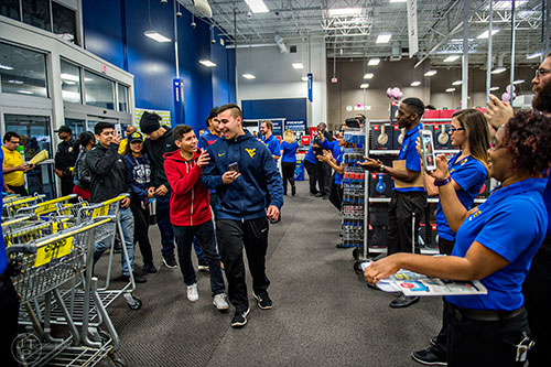 Michael Alipio (center left) and Alan Haddad are the first customers inside Best Buy Perimeter in Atlanta for Gray Thursday on Thanksgiving night, Thursday, November 26, 2015. Alipio and Haddad set up camp around 3 p.m. on Wednesday to be the first in line. 