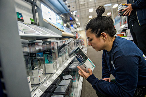 Michele Thaxton looks at a Fitbit inside Best Buy Perimeter in Atlanta during Gray Thursday on Thanksgiving night, Thursday, November 26, 2015. 
