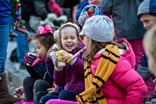 Kate Stevens (center) laughs as she drinks hot chocolate before the start of the 2015 Children's Christmas Parade in Atlanta on Saturday, December 5, 2015. 