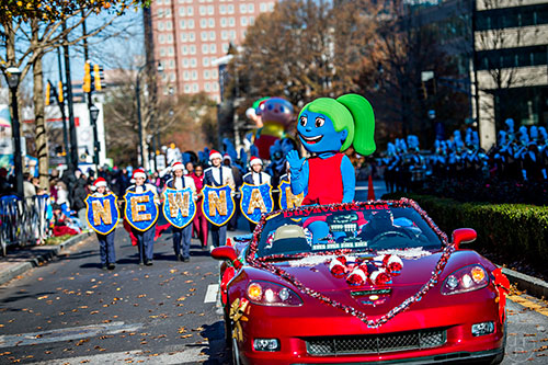 Hope, one of Children's Healthcare of Atlanta's mascots, waves to the crowd during the 2015 Children's Christmas Parade in Atlanta on Saturday, December 5, 2015. 