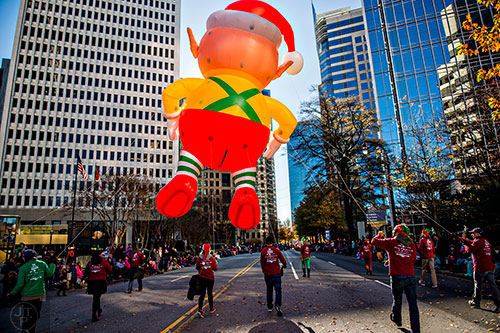 An elf balloon is guided down Peachtree St. during the 2015 Children's Christmas Parade in Atlanta on Saturday, December 5, 2015. 