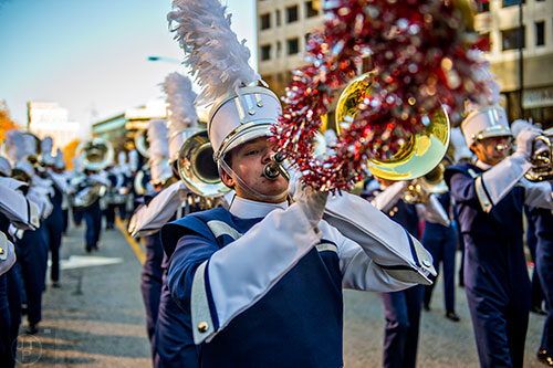 Nathaniel Carr plays his trombone as he marches with the North Paulding High School band in the 2015 Children's Christmas Parade in Atlanta on Saturday, December 5, 2015. 
