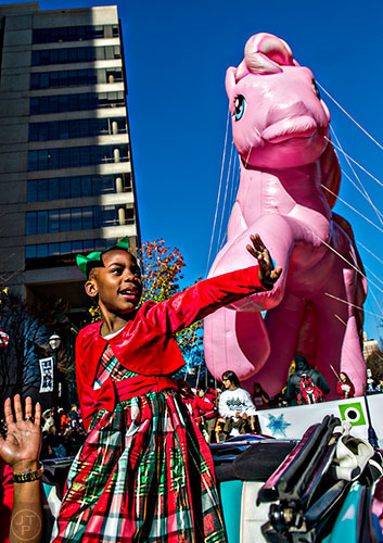 Madison Arnold waves to the crowd during the 2015 Children's Christmas Parade in Atlanta on Saturday, December 5, 2015. 