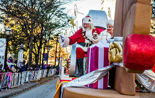 Santa and Mrs. Claus wave from atop their float during the 2015 Children's Christmas Parade in Atlanta on Saturday, December 5, 2015. 