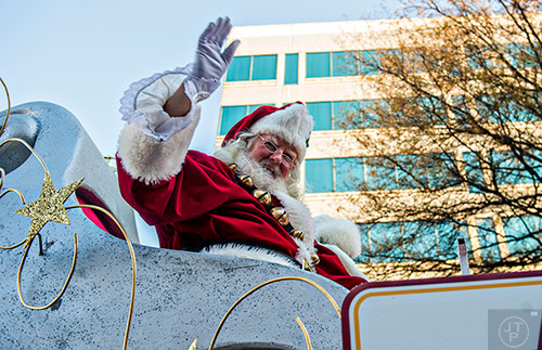 Santa waves from atop his float during the 2015 Children's Christmas Parade in Atlanta on Saturday, December 5, 2015. 