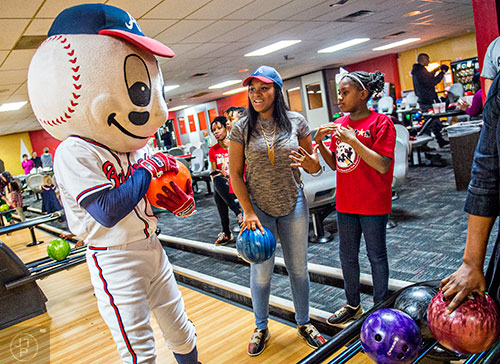 Atlanta Braves mascot Homer (left) messes around with Sheneah Hill and Aaliyah Womack during the Atlanta Braves' Military Basebowl event at Midtown Bowl in Atlanta on Saturday, December 5, 2015. 