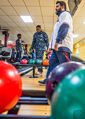 Atlanta Braves alumni Johnny Estrada (right) and Steffon Selby bowl against one another during the Atlanta Braves' Military Basebowl event at Midtown Bowl in Atlanta on Saturday, December 5, 2015.