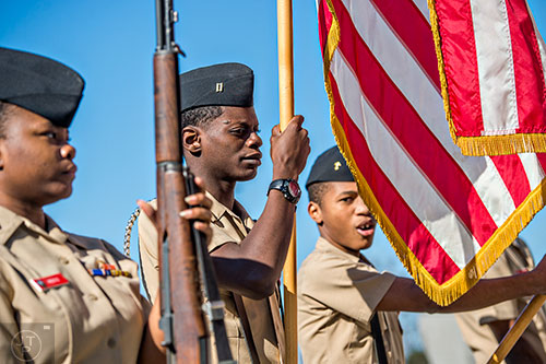 D'Andrea Pierce (left), Joshua Sidwell and Enrico Dallas march in the colors during the 74th anniversary of Pearl Harbor ceremony at the DeKalb County School District Administrative and Instructional Complex in Stone Mountain on Monday, December 7, 2015.  