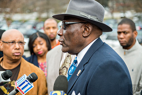President of the Cobb County branch of the Southern Christian Leadership Coalition Ben Williams (center) calls for the immediate termination of Cobb County Police Officer Maurice Lawson outside of the Cobb County Police Department Headquarters in Marietta on Thursday, December 10, 2015. 