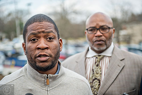 Brian Baker (left) is flanked by former Atlanta councilman Derrick Boazman as he calls for the immediate termination of Cobb County Police Officer Maurice Lawson outside of the Cobb County Police Department Headquarters in Marietta on Thursday, December 10, 2015. 