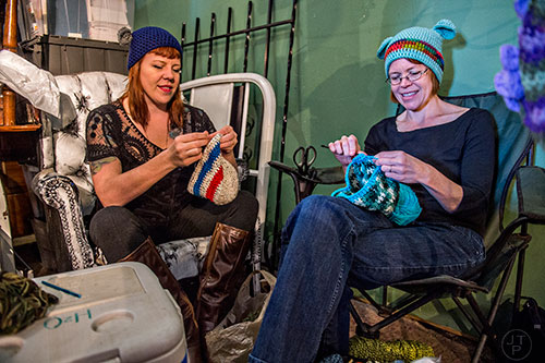 Kate Crosby (left) and Amy Adams crochet hats as they wait for customers during the Bazaar on the Beltline at The Hanger off of the Eastside Trail in Atlanta on Saturday, December 12, 2015. 