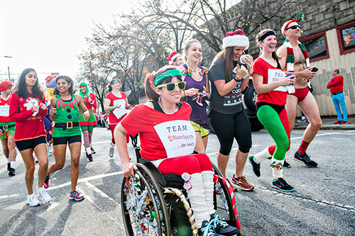 Maggie Frederick (center) participates in the annual Atlanta Santa Speedo Run at Manuel's Tavern in Atlanta on Saturday, December 12, 2015. 