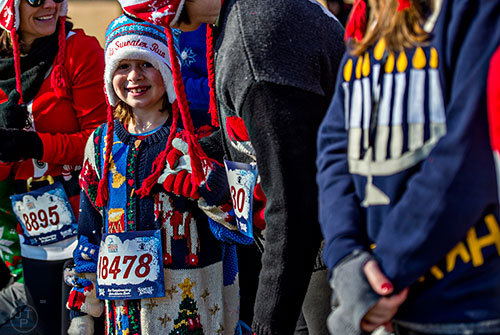 Ella Shevlin (left) waits for the start of the Ugly Sweater Run at Piedmont Park in Atlanta on Saturday, December 19, 2015. 