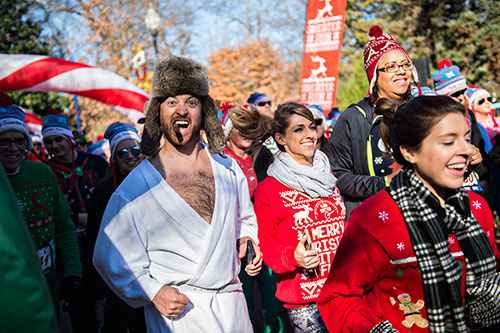 Wes Vaughn (left) takes off from the starting line during the Ugly Sweater Run at Piedmont Park in Atlanta on Saturday, December 19, 2015. 